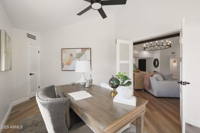 a view of a livingroom with workspace and a window