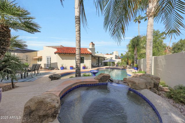a wooden bench sitting in the middle of a yard