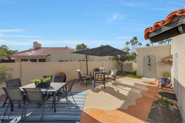 a view of a backyard with furniture and a fire pit
