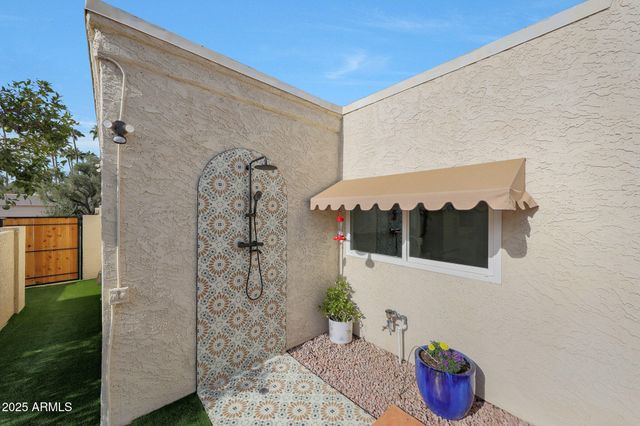 a view of a patio with table and chairs and potted plants
