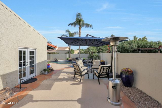 a patio with tables and chairs