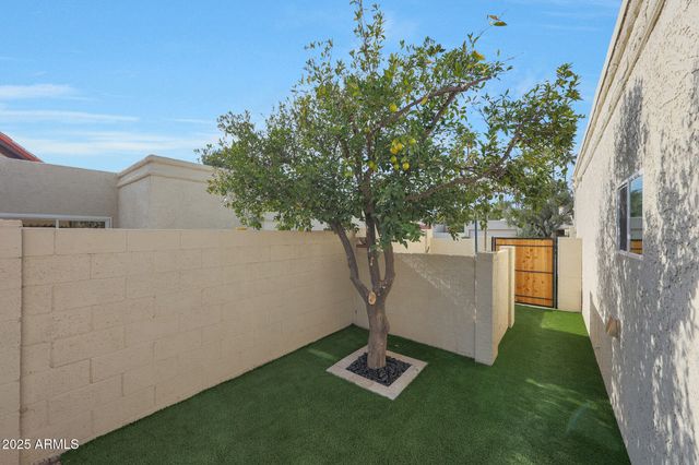 a view of a patio with table and chairs potted plants
