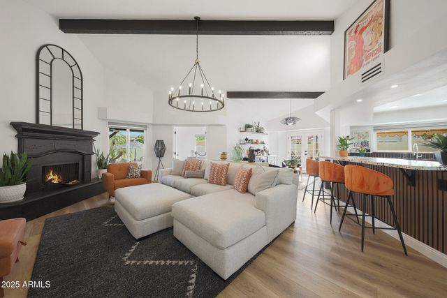 a living room with furniture a dining table and a fireplace