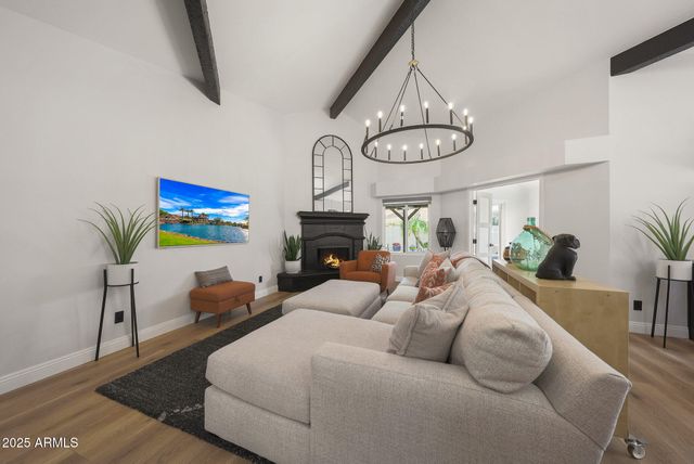a bedroom with furniture and a chandelier