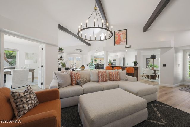 a living room with furniture a clock and a window