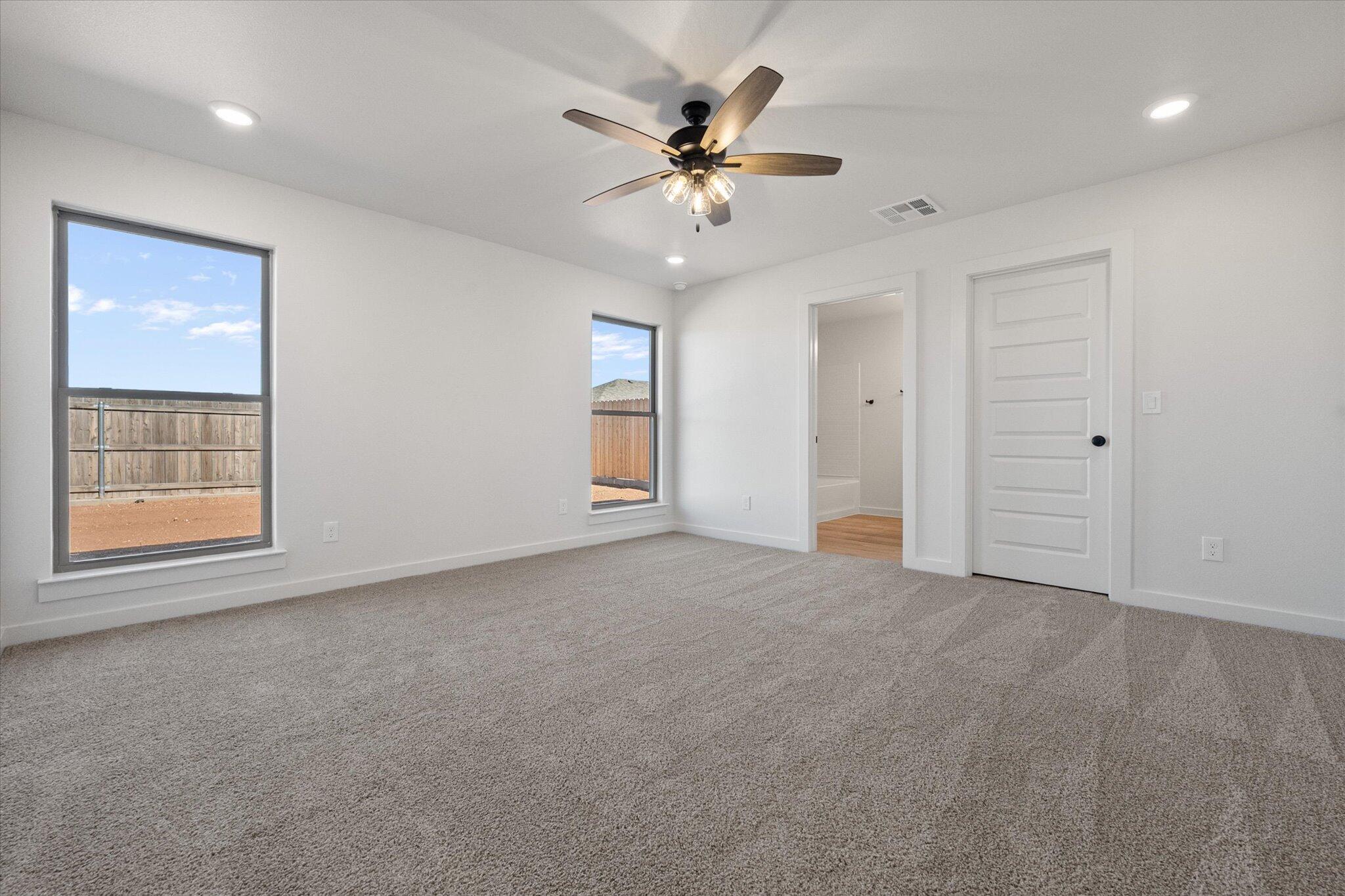 606 East 22nd Street Wolfforth, TX 79382 - Photo 12 of 19 a view of an empty room with a ceiling fan and window