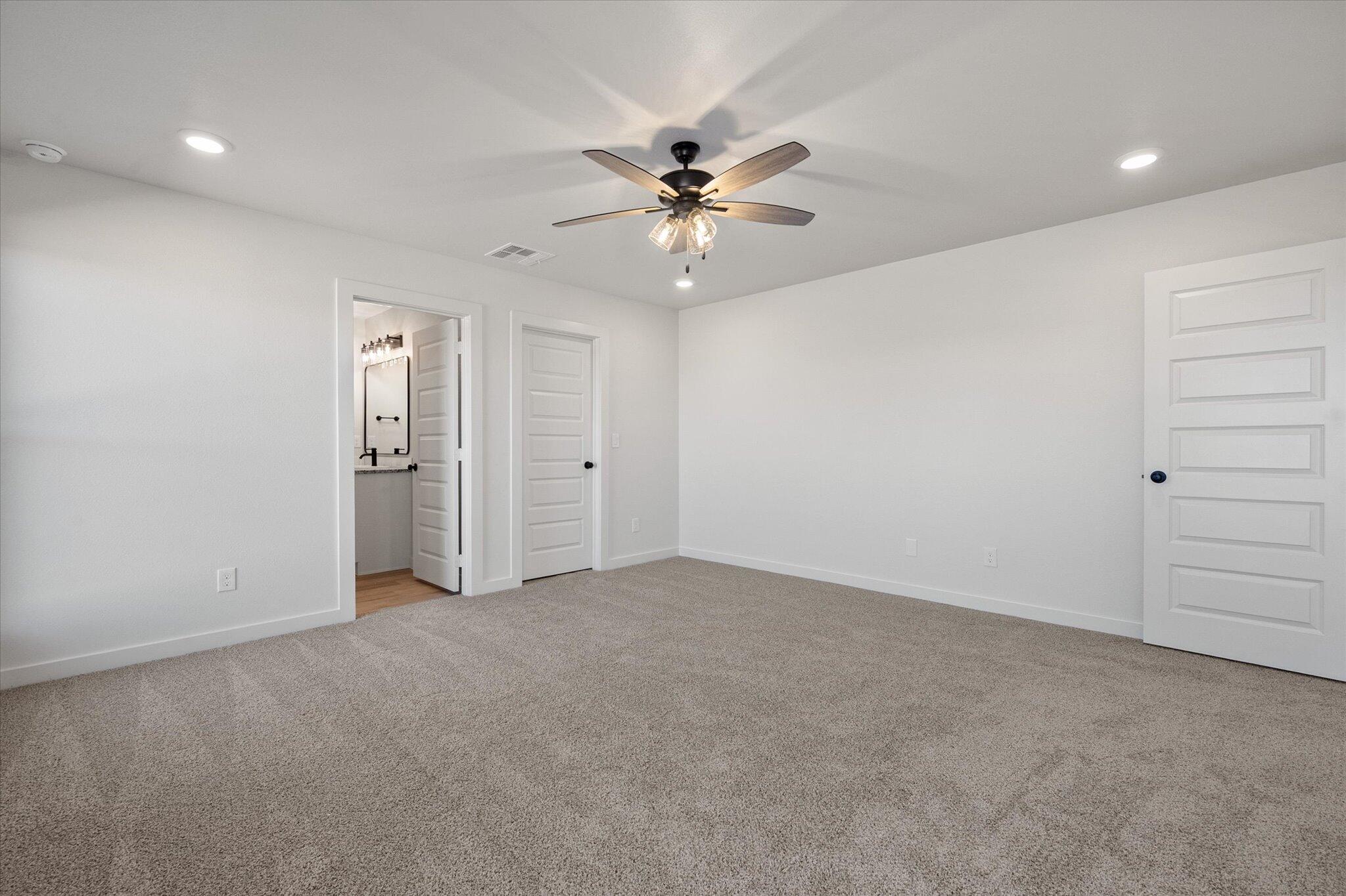 606 East 22nd Street Wolfforth, TX 79382 - Photo 13 of 19 an empty room with closet and a ceiling fan