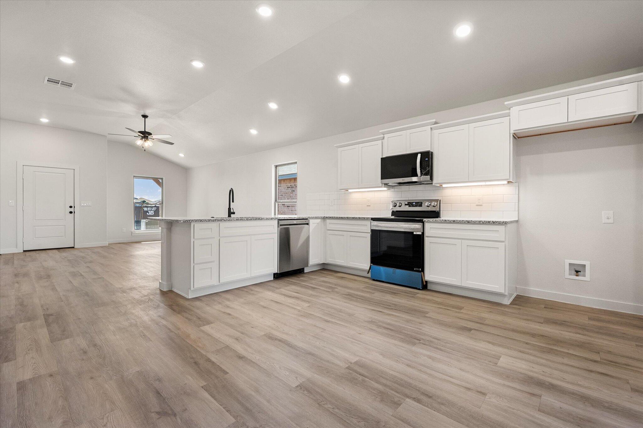 606 East 22nd Street Wolfforth, TX 79382 - Photo 10 of 19 a view of kitchen with microwave and cabinets