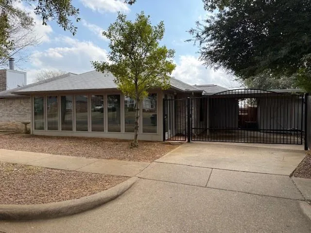 a view of a house with a backyard and a tree