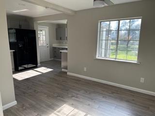 7828 Old Auburn Road Citrus Heights, CA 95610 - Photo 9 of 12 an empty room with wooden floor closet and windows
