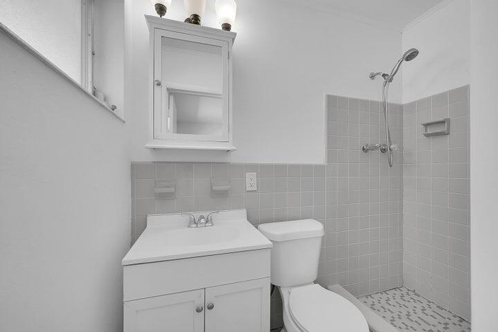 1308 South Congress Avenue Delray Beach, FL 33445 - Photo 12 of 30 a bathroom with a sink toilet and shower