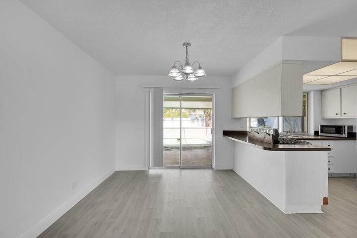 1308 South Congress Avenue Delray Beach, FL 33445 - Photo 19 of 30 a kitchen with granite countertop a sink and cabinets