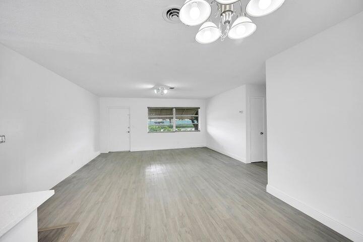 1308 South Congress Avenue Delray Beach, FL 33445 - Photo 27 of 30 an empty room with wooden floor and windows
