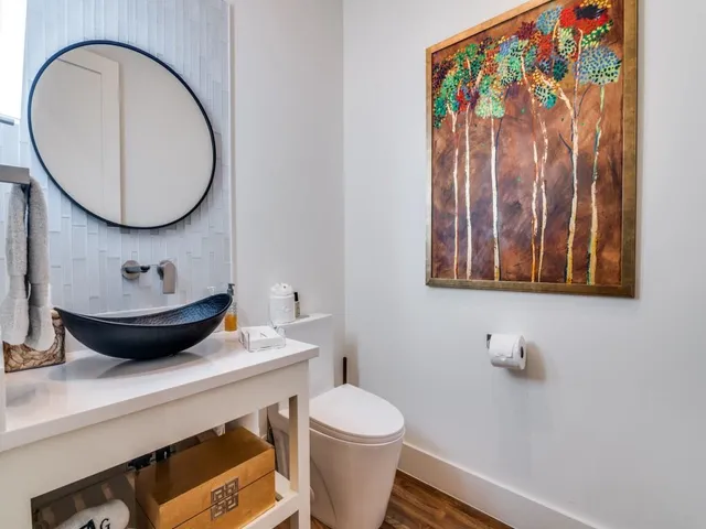 a bathroom with a toilet a sink and a mirror