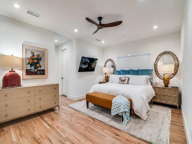 a bedroom with a large bed and a dresser