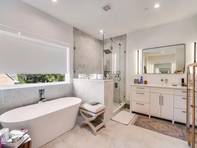 a bathroom with a toilet sink a mirror and bathtub