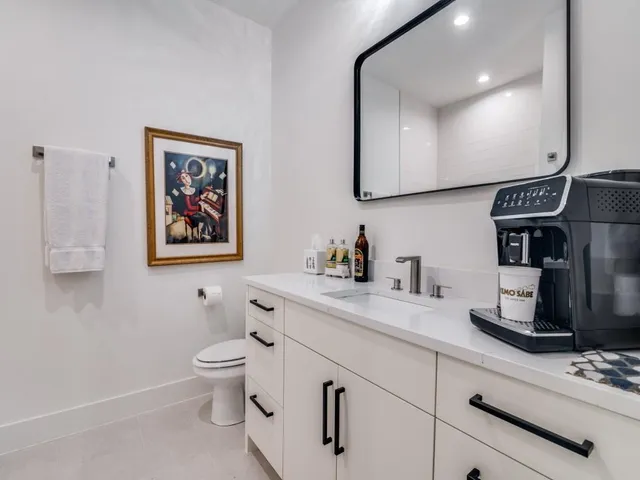 a bathroom with a toilet a sink and mirror