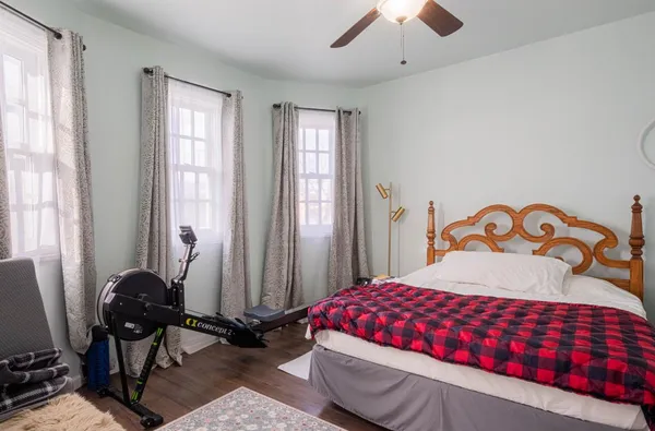 a bedroom with a hardwood floor and a sink