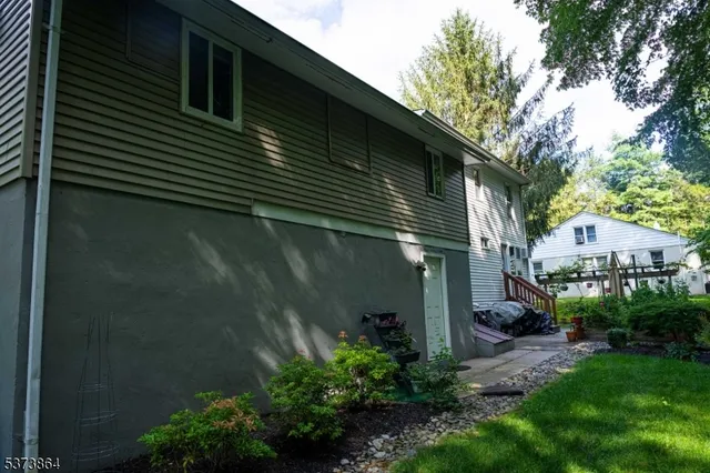 a backyard of a house with plants and tree