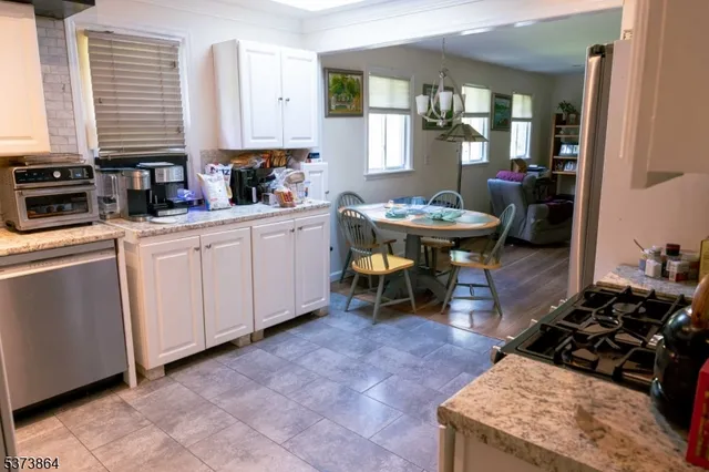 a kitchen with stainless steel appliances granite countertop a stove a sink dishwasher and cabinets