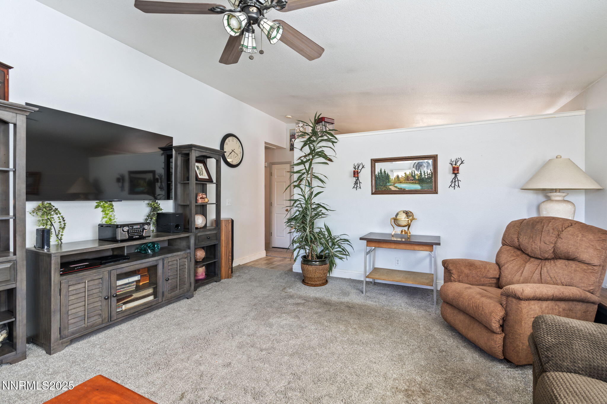 5886 Wishbone Court Sun Valley, NV 89433 - Photo 11 of 42 a living room with furniture kitchen view and a flat screen tv