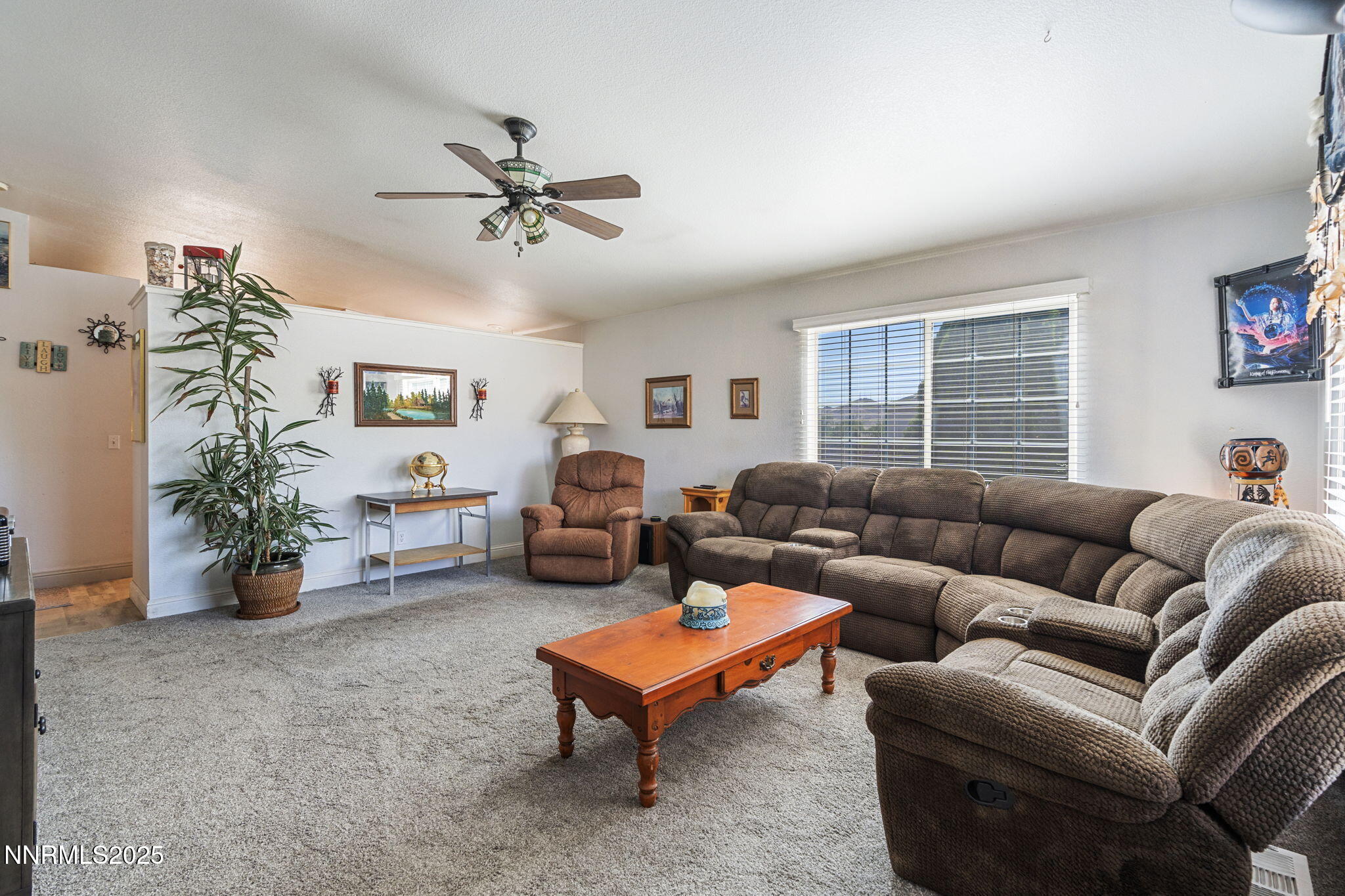 5886 Wishbone Court Sun Valley, NV 89433 - Photo 12 of 42 a living room with furniture a chandelier and a window