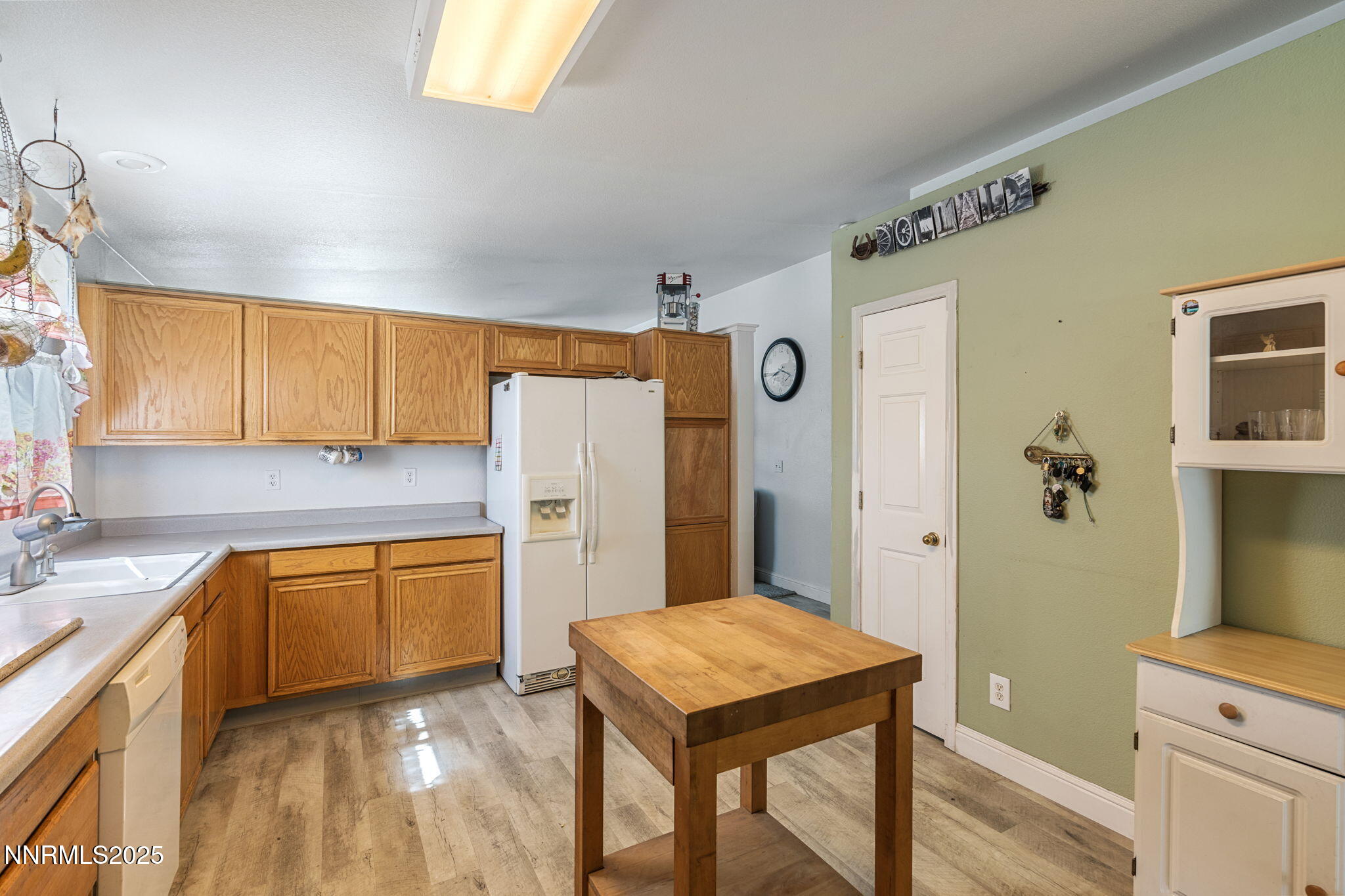 5886 Wishbone Court Sun Valley, NV 89433 - Photo 19 of 42 a kitchen with stainless steel appliances granite countertop a refrigerator a sink dishwasher and a stove with wooden floor