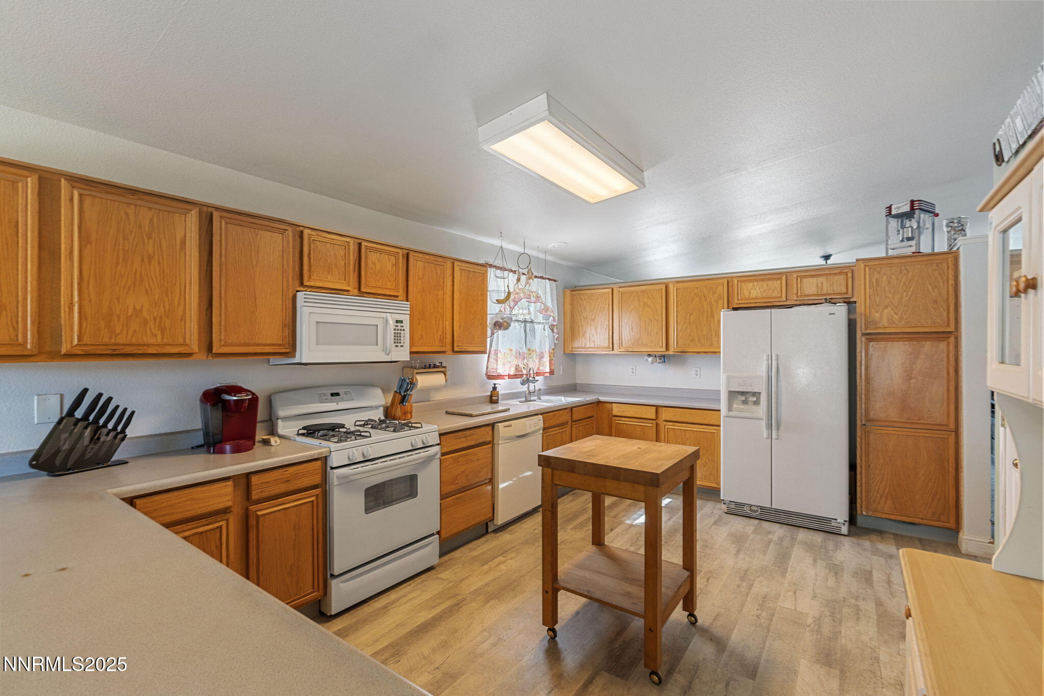 5886 Wishbone Court Sun Valley, NV 89433 - Photo 20 of 42 a kitchen with stainless steel appliances granite countertop sink refrigerator and cabinets