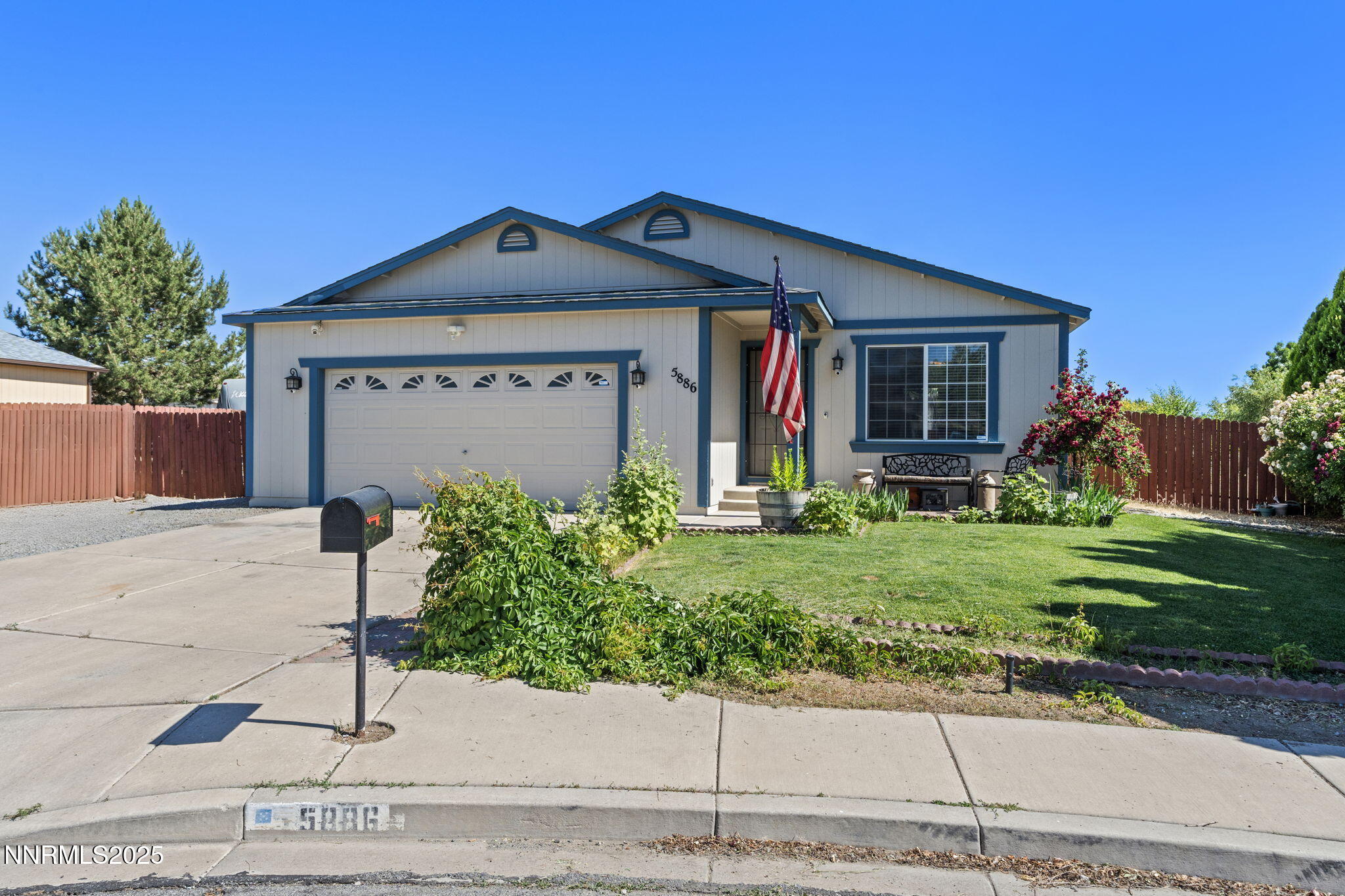 5886 Wishbone Court Sun Valley, NV 89433 - Photo 2 of 42 a front view of a house with garden