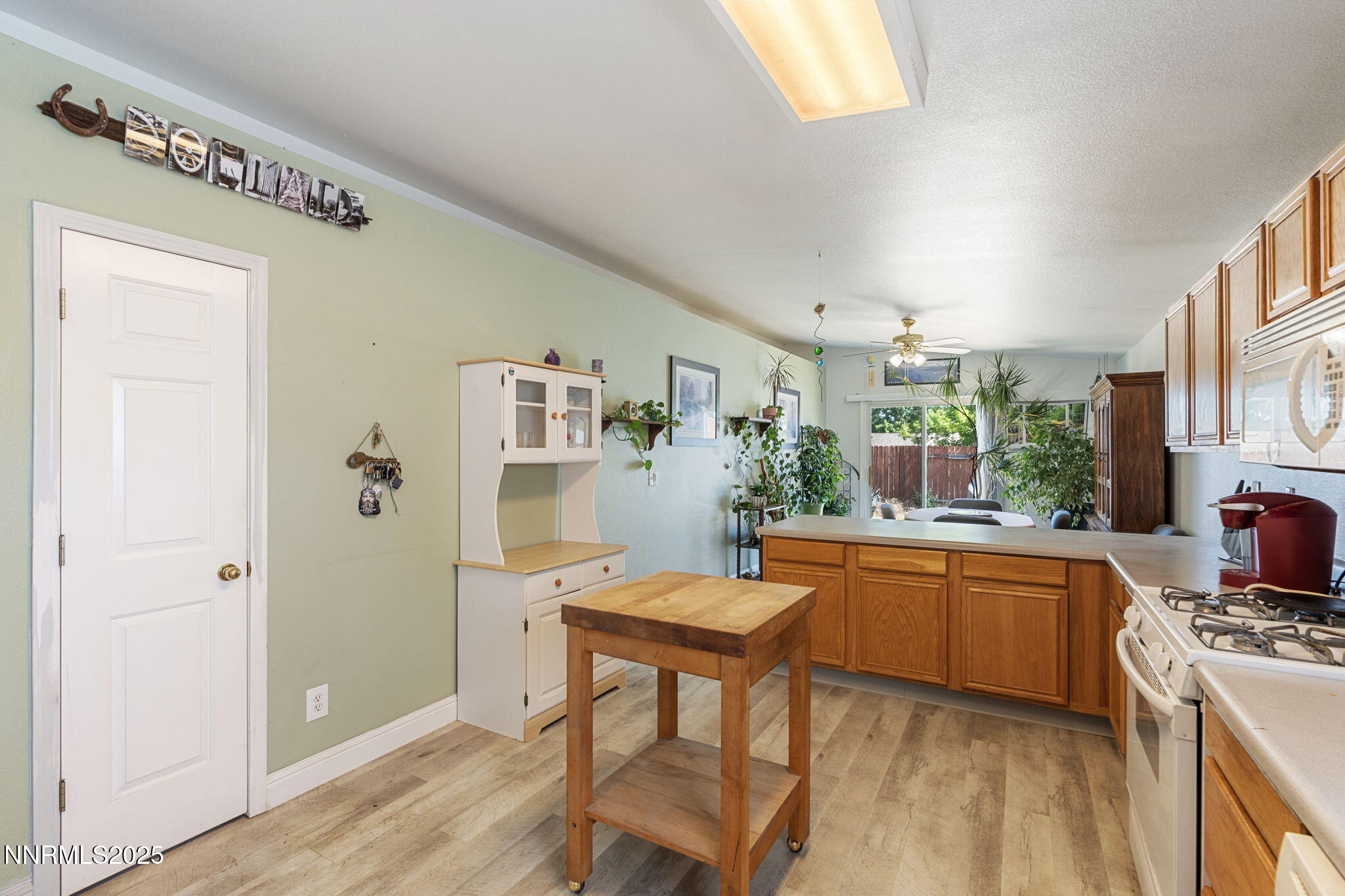 5886 Wishbone Court Sun Valley, NV 89433 - Photo 21 of 42 a kitchen with stainless steel appliances granite countertop a refrigerator and a stove top oven