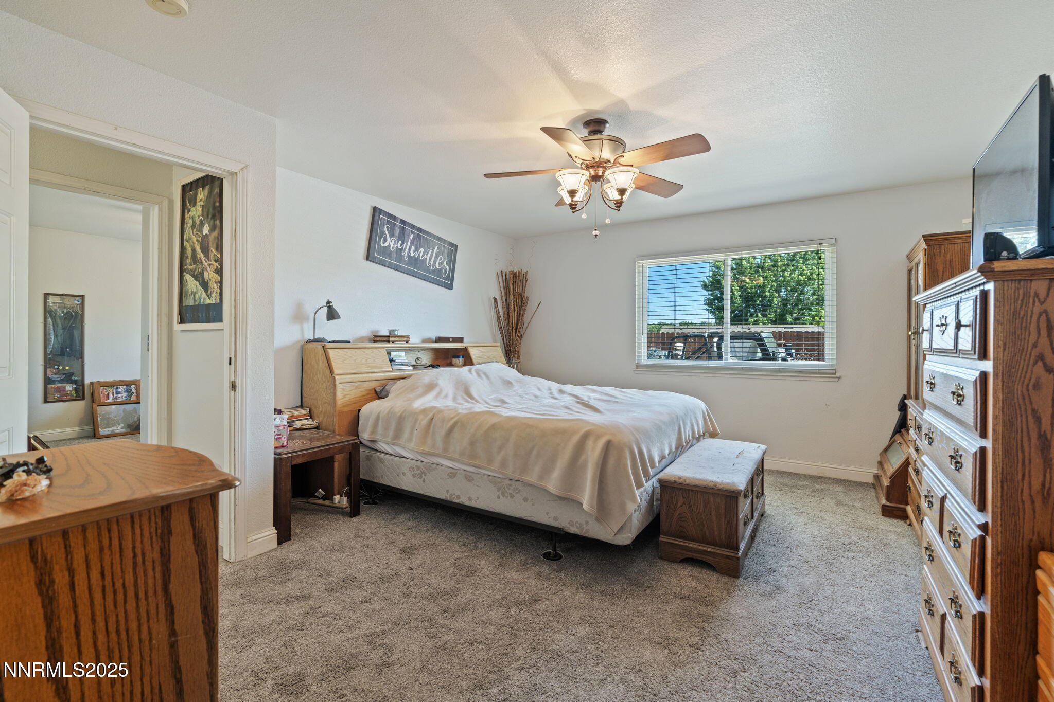 5886 Wishbone Court Sun Valley, NV 89433 - Photo 24 of 42 a bedroom with a bed and a flat tv screen on the dresser