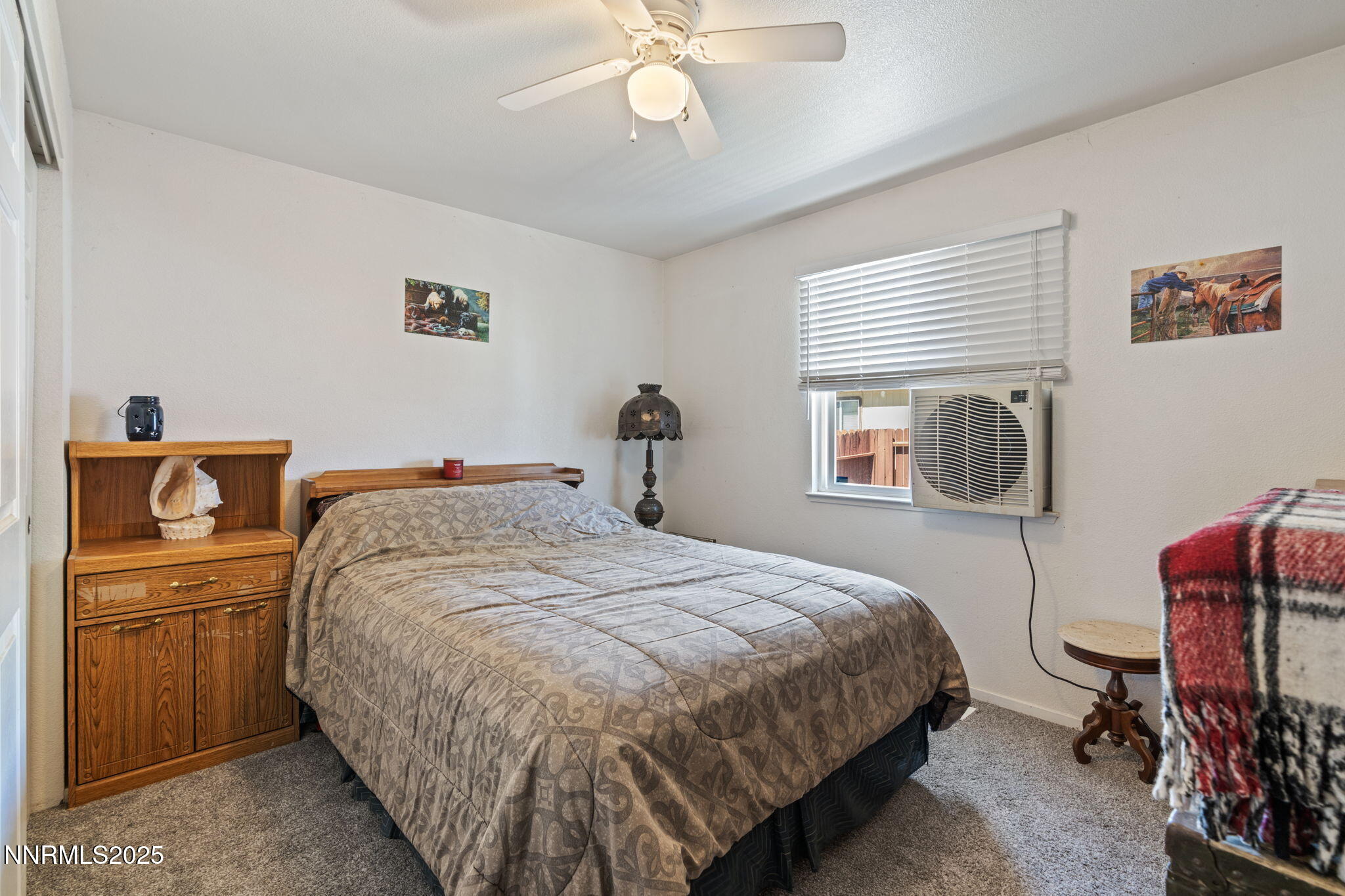 5886 Wishbone Court Sun Valley, NV 89433 - Photo 26 of 42 a bedroom with a bed and a chandelier