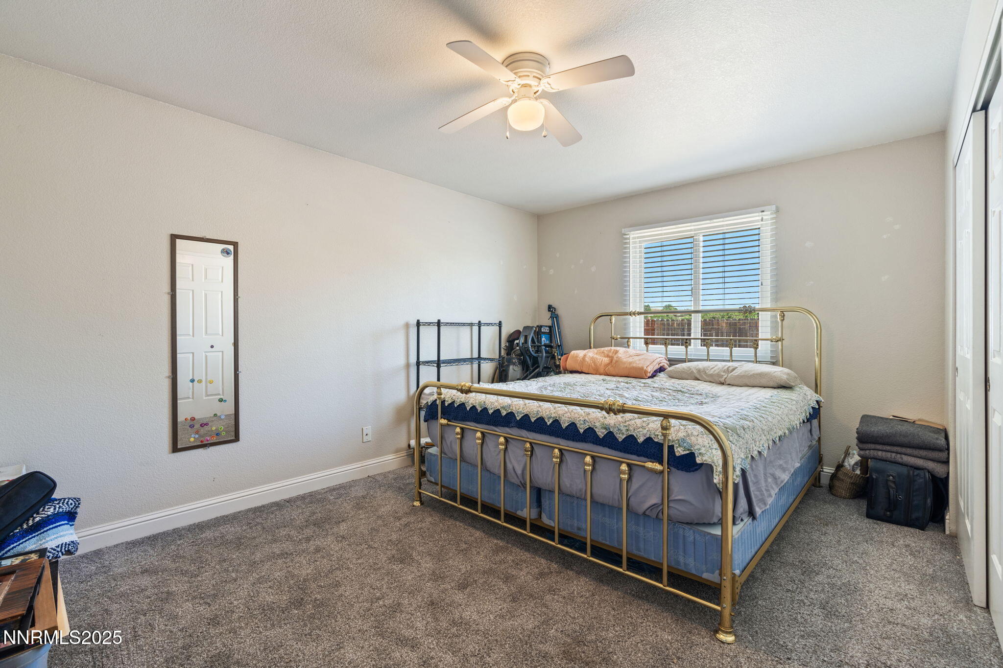 5886 Wishbone Court Sun Valley, NV 89433 - Photo 27 of 42 a bedroom with a bed chandelier and a window