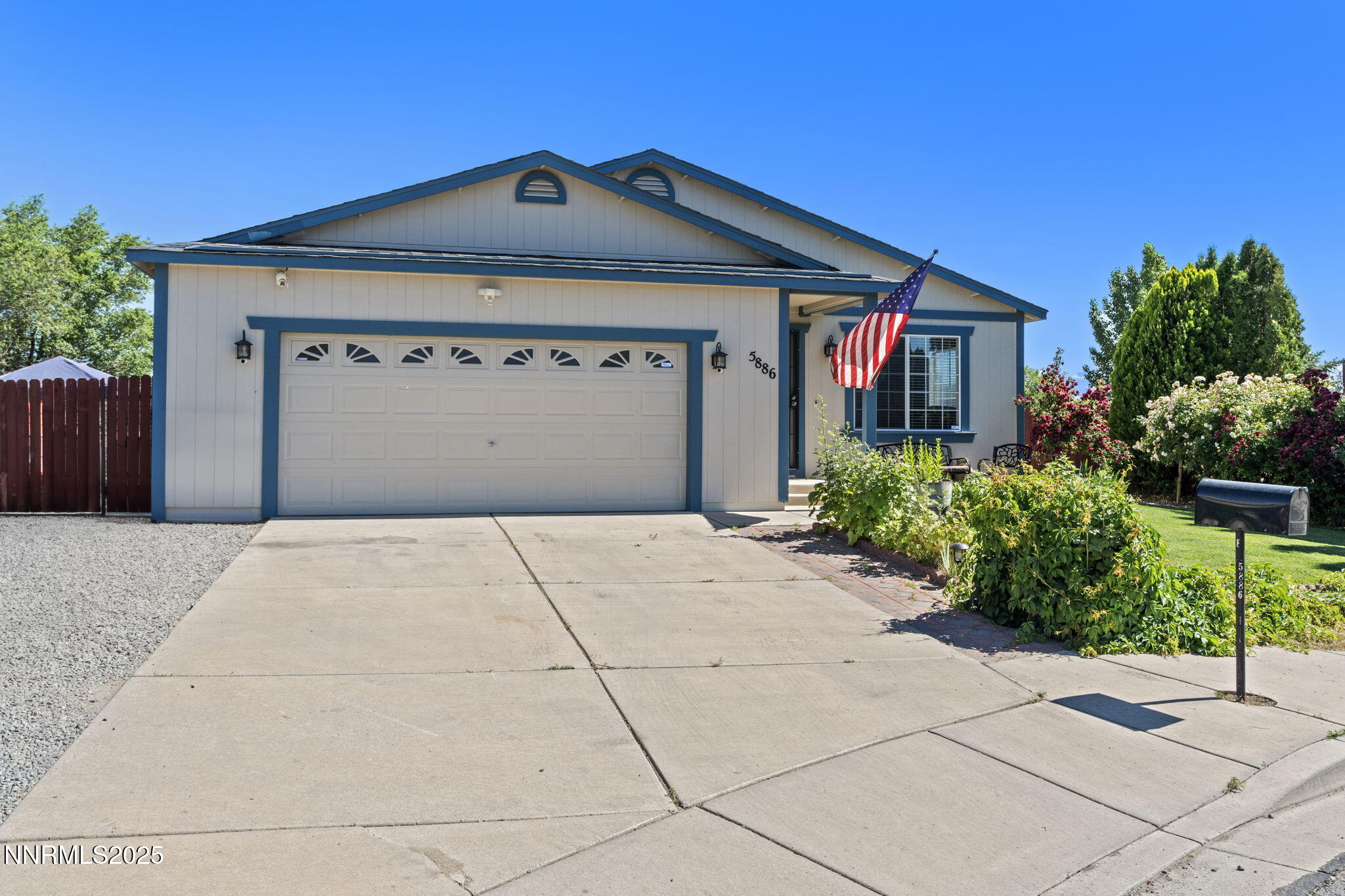 5886 Wishbone Court Sun Valley, NV 89433 - Photo 3 of 42 a front view of a house with a yard and garage