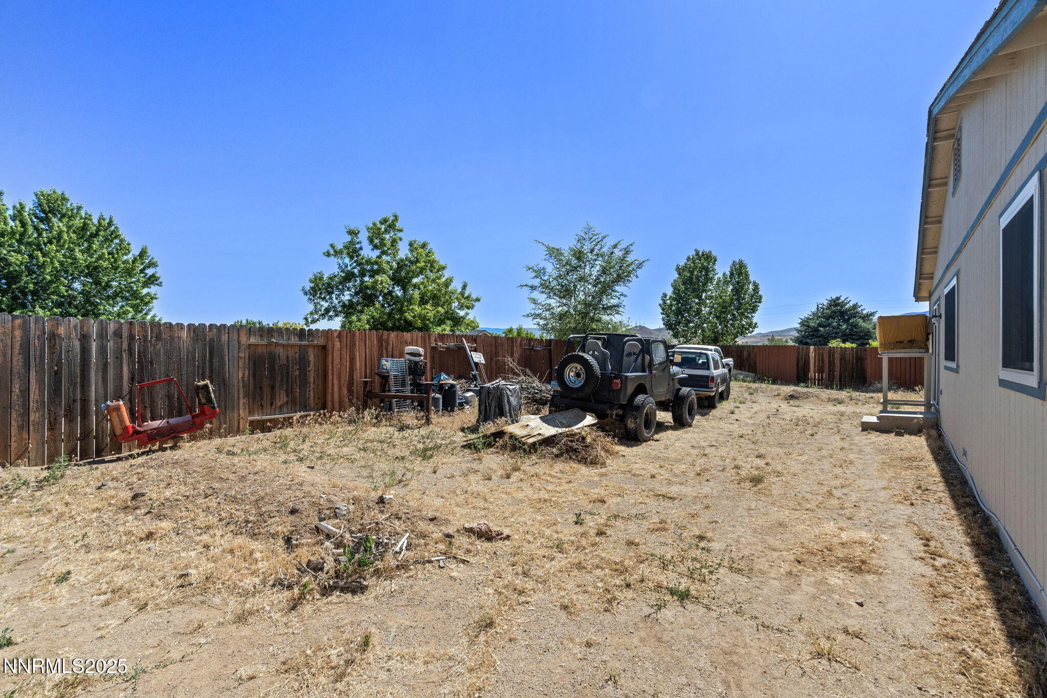 5886 Wishbone Court Sun Valley, NV 89433 - Photo 35 of 42 a view of backyard with a table and chairs with wooden fence