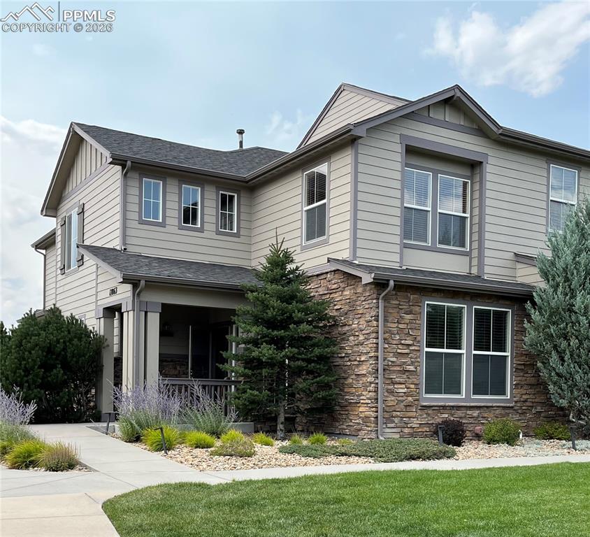 17063 Blue Mist Grove Monument, CO 80132 - Photo 1 of 33 a front view of a house with a yard and garage