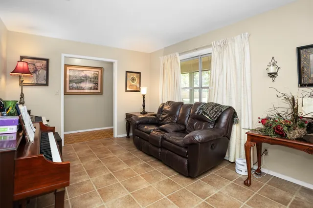 a living room with furniture a window and a flat screen tv