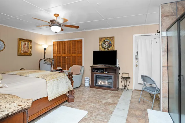 a bedroom with a bed and a flat screen tv