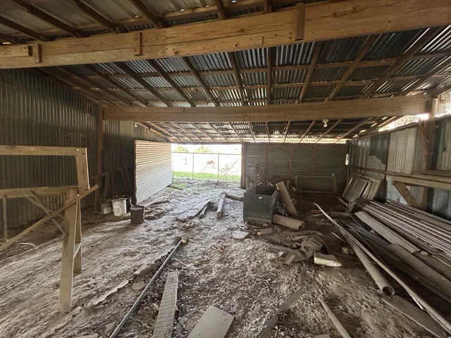 a view of a blue house with a yard