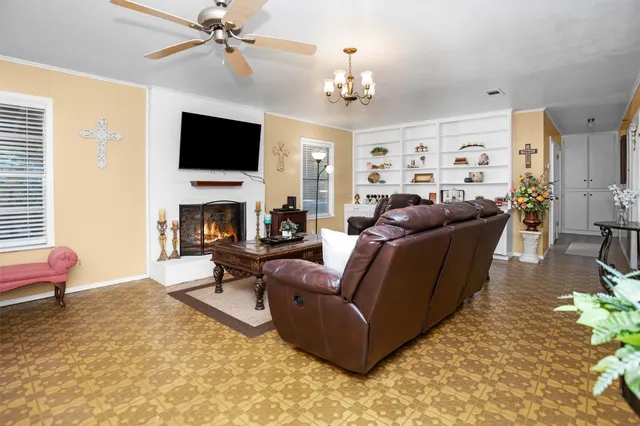 a living room with furniture a fireplace and a flat screen tv