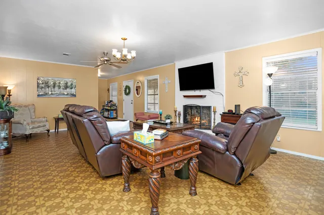 a living room with furniture a fireplace and a flat screen tv