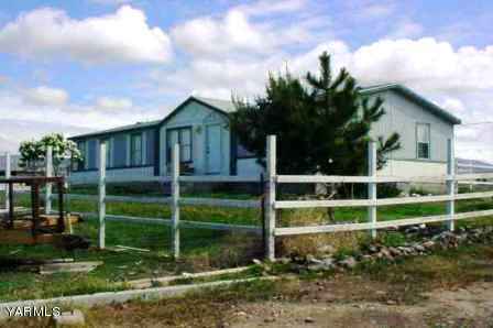 301 Prairie Road Moxee, WA 98936 - Photo 1 of 1 a view of a house with a yard and a garden
