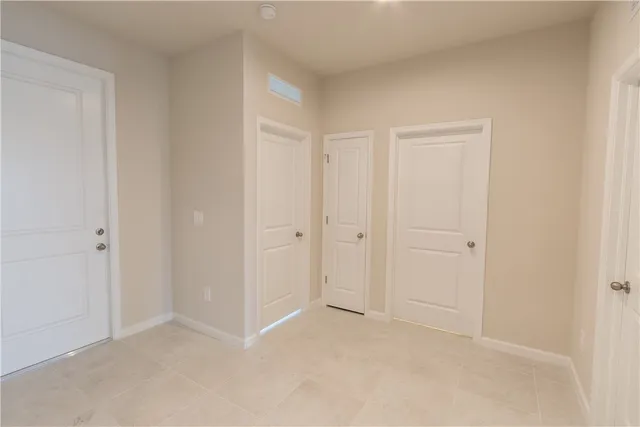 a view of an empty room and closet area