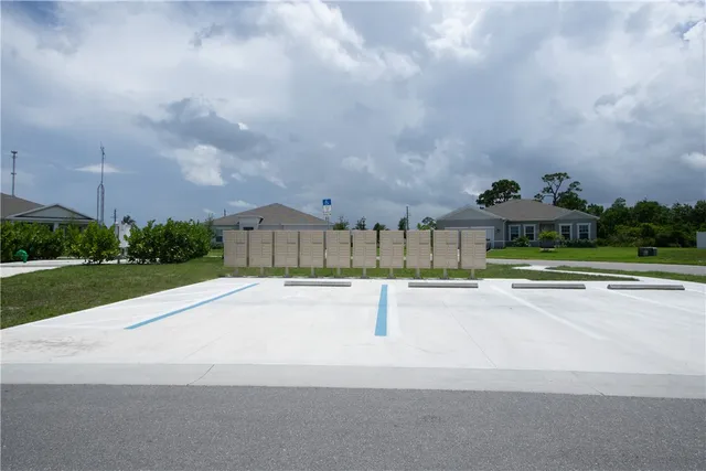 a view of a street with houses in the background