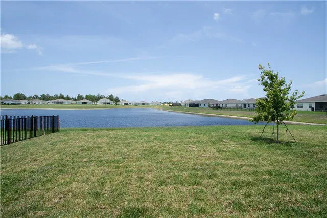 a view of a lake with houses in the back