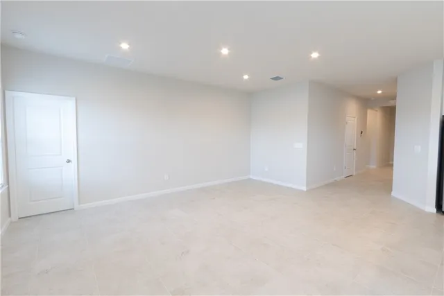 an empty room with a empty space and windows