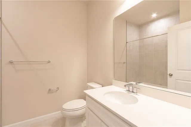 a bathroom with a sink toilet and a mirror
