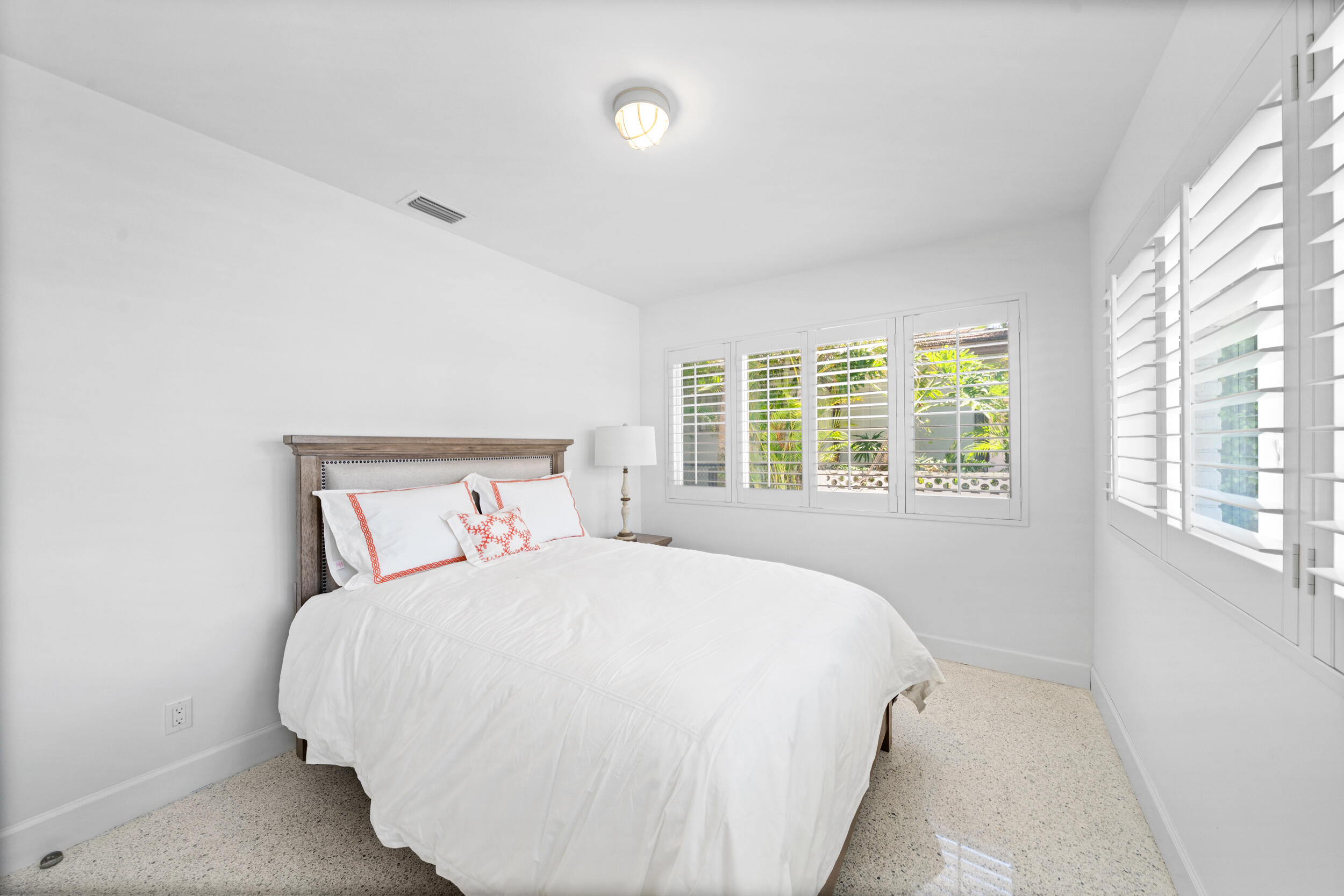 2259 Ibis Isle Road East Palm Beach, FL 33480 - Photo 16 of 35 a bedroom with a bed and a window