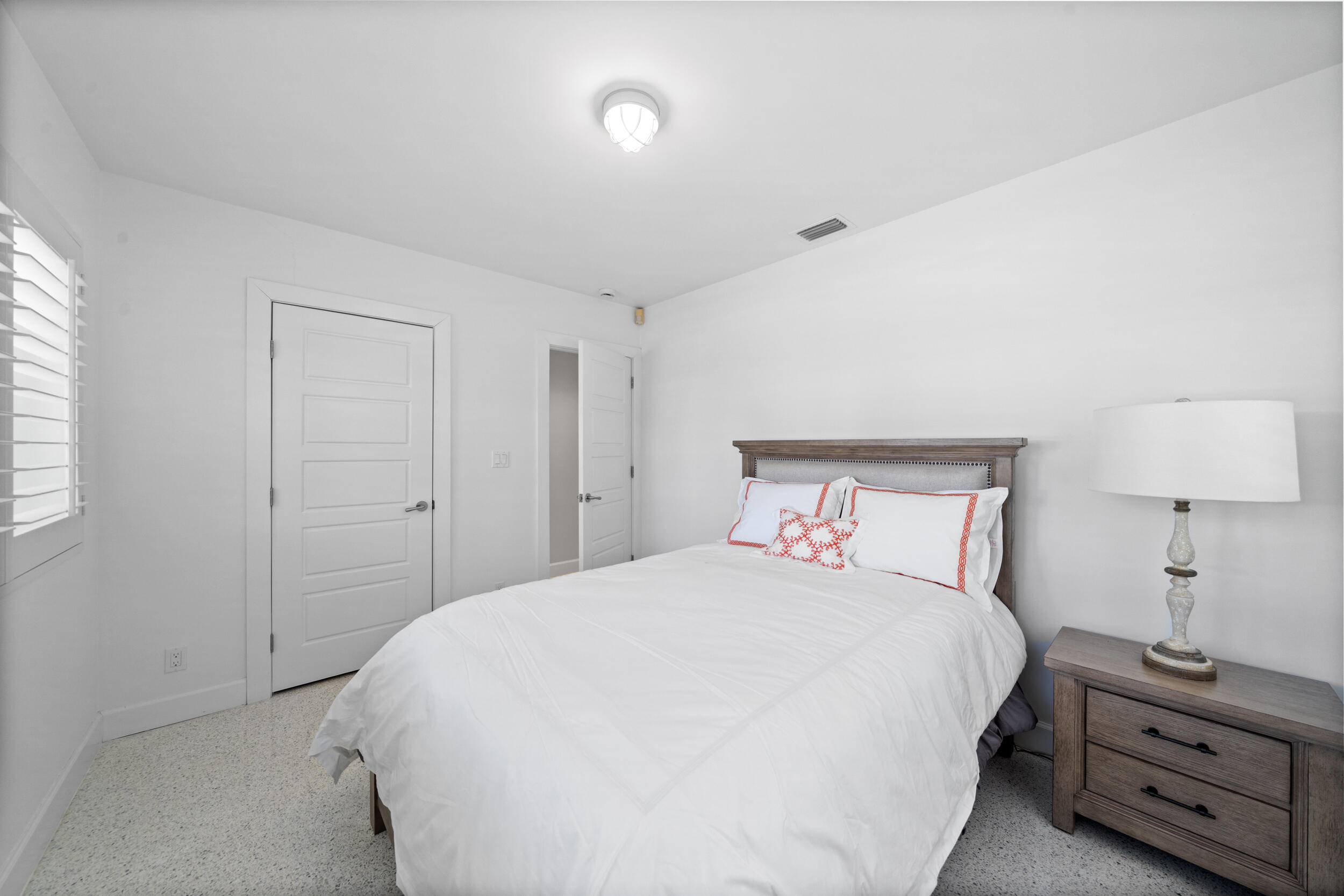 2259 Ibis Isle Road East Palm Beach, FL 33480 - Photo 17 of 35 a bedroom with a bed and a lamp on the dresser