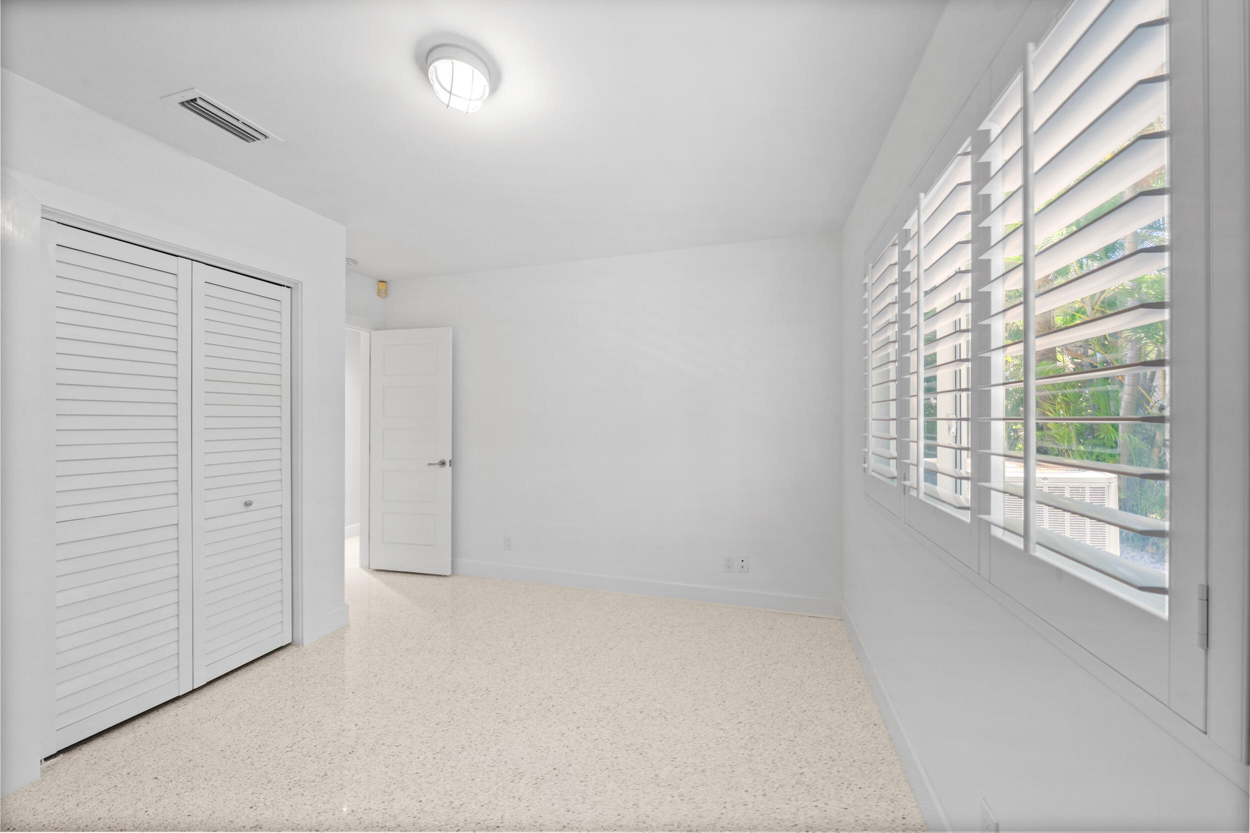 2259 Ibis Isle Road East Palm Beach, FL 33480 - Photo 19 of 35 an empty room with windows